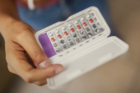 Teenage Girl Holding Birth Control Pills