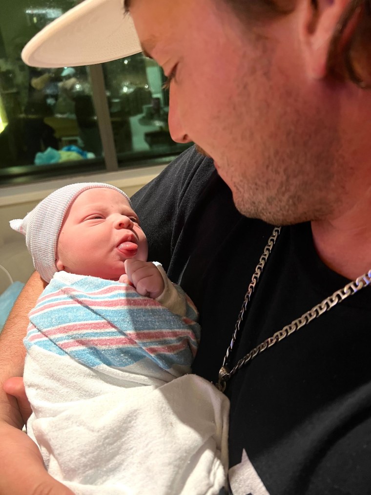 Dewey Bennet holding his son, Dewey Lester Bennett, IV.