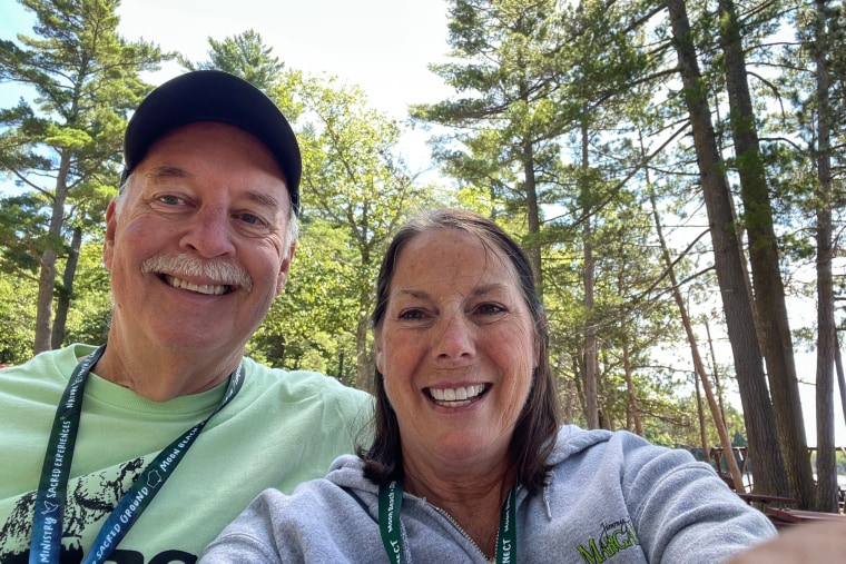 Chuck, left, and Sharon Zimmer take a selfie outside near trees