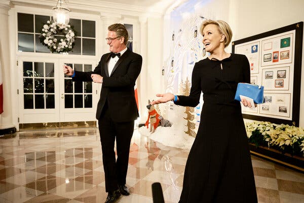 Joe Scarborough and Mika Brzezinski, wearing black and looking to the side.