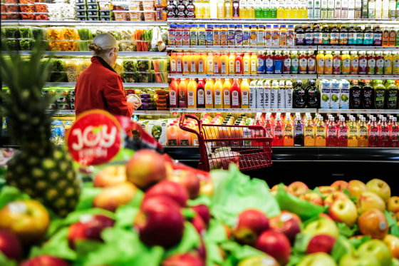 Fruit is displayed as a woman shops in a supermarket