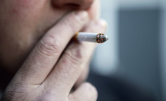 A man smokes a cigarette.