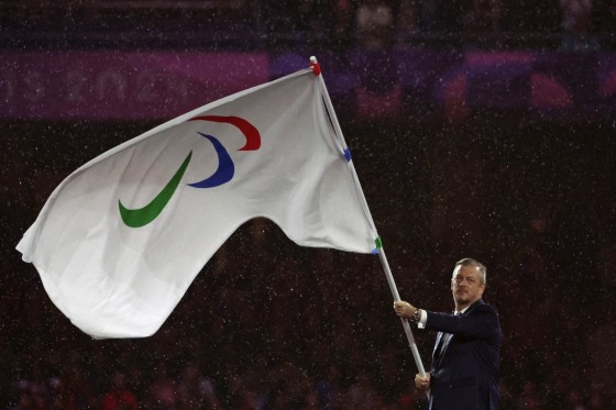 250306-andrew-parsons-paralympics-mn-1355-1b6a9b-1 Andrew Parsons, president of the International Paralympic Committee, waves the Paralympics flag during the closing ceremony of th eParis 2024 Paralympic Games.